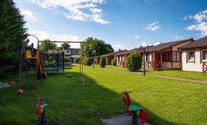 a yard with a playground with a slide at Domki Bliźniak in Ustka