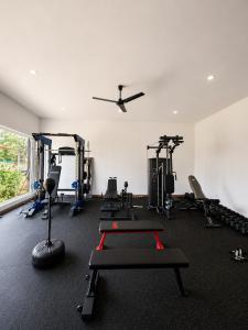 a gym with several tread machines and a ceiling fan at Casa Frank - Sophiassuites506 in Brasilito