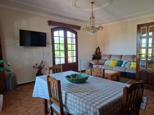 a living room with a table and a couch at Sitio dos Machados in Póvoa de Lanhoso