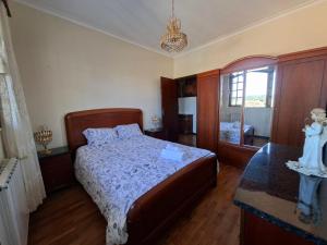 a bedroom with a bed and a table and a window at Sitio dos Machados in Póvoa de Lanhoso