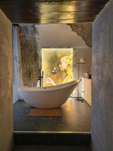 a painting of a woman in a bath tub in a bathroom at Plebiscito Suite Apartment in Naples +29 photos