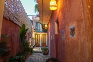 an alley with red buildings and a light fixture at Domus Santa Barbara Apartments with Pool in Santo Domingo