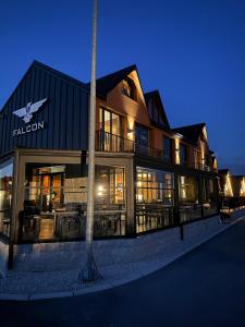 a building with tables and chairs in front of it at Hotel Falcon in Žabljak