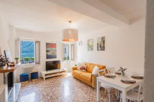ein Wohnzimmer mit Sofa und Tisch in der Unterkunft Family Nest on Lake Como by Rent All Como in Argegno