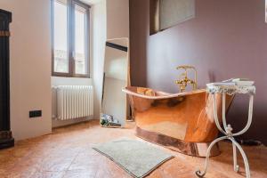 a bathroom with a copper tub in a room at Castravalva Villa by Rent All Como in Mezzegra +40 photos