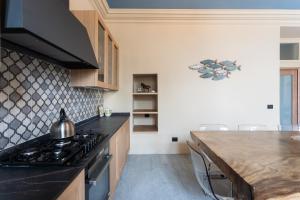 a kitchen with a stove and a counter top at Castravalva Villa by Rent All Como in Mezzegra