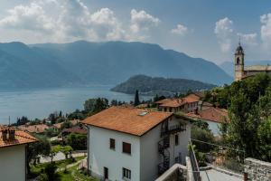 a view of a town with a church and a lake at Castravalva Villa by Rent All Como in Mezzegra