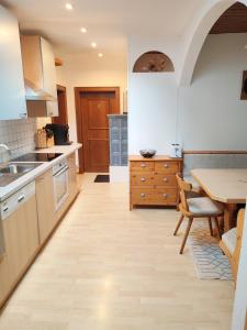 a kitchen with a sink and a table in it at Haus Enzian in Mittersill