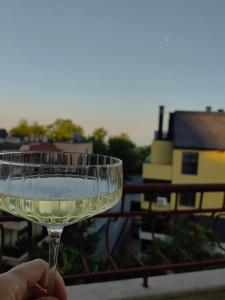 a hand holding a glass of wine with a view at Family Hotel Brilliance in Varna City