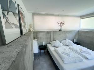 a bedroom with a large white bed in a room at Studio Margriet in Bergen