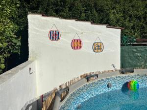 a swimming pool with three basketball signs on a wall at DEl Rey Guest House in Tomar