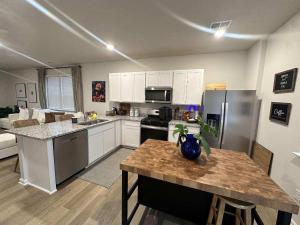 a kitchen with white cabinets and a table in it at Milford House in Milford