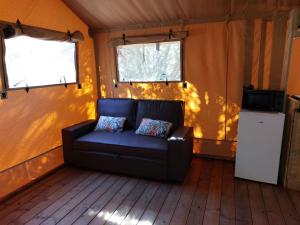 a couch sitting in the middle of a room at Gîte les 7 saveurs in Cucugnan +15 photos