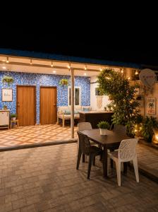 a patio with a wooden table and chairs at Aanadam Resort in Jaipur