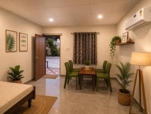 a room with a table and chairs and a bed at Aanadam Resort in Jaipur
