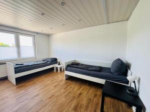 a room with two beds and a table in it at CityStay House 42 in Bremerhaven