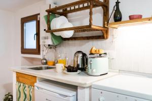 a kitchen counter with a coffee maker and a sink at Patio Morisco - WIFI - free parking in Órgiva +44 photos