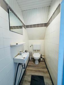 a bathroom with a sink and a toilet at CityStay House 42 in Bremerhaven +10 photos