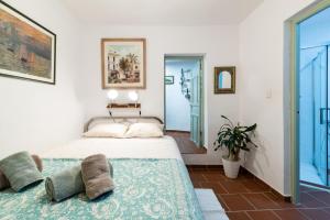 a bedroom with a bed and a large window at Patio Morisco - WIFI - free parking in Órgiva