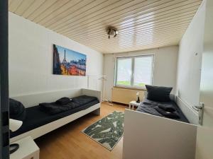 a bedroom with a bed and a couch in a room at CityStay House 42 in Bremerhaven