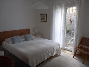 a bedroom with a bed and a large window at Les mimosas in Collioure +14 photos