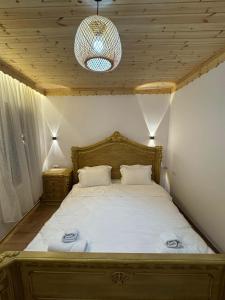 a bedroom with a bed with two towels on it at Golden Guest House in Gjirokastër +6 photos