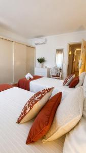 two beds with pillows on them in a room at Villa Cerro in Albufeira