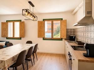 a kitchen with a table and chairs in a room at CozyCatalonia - Exclusive Attic in Central Blanes in Blanes