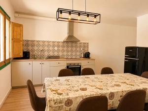 a dining room with a table and a kitchen at CozyCatalonia - Exclusive Attic in Central Blanes in Blanes