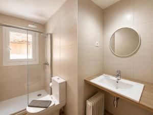 a bathroom with a sink and a toilet and a mirror at CozyCatalonia - Exclusive Attic in Central Blanes in Blanes