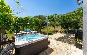 a jacuzzi tub in a yard with trees at My Dalmatia - Villa Mandorla with private pool and Jacuzzi in Zadar