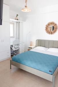 a bedroom with a bed and a desk and a chair at Orion Sea View Studio in Parasporos