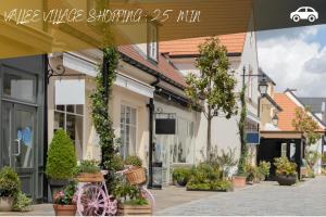 a pink bike parked in front of a building at Le Nid De Mouroux - Disney 20 min - Clim & Parking in Mouroux