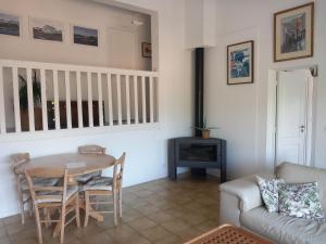 a living room with a table and a couch at Les mimosas in Collioure
