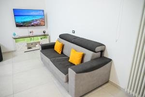 a living room with a couch with yellow pillows at Victry's Houses Chiaia in Naples