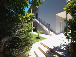 an external view of a house with stairs and plants at Rina Apartment- with barbecue and free parking in Kaštela