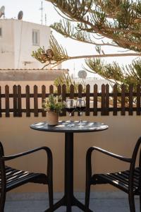 a table with two glasses of wine on a patio at NaxosAir1 in Naxos Chora