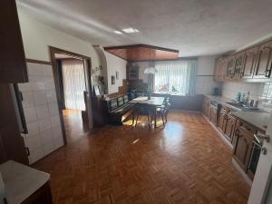 a kitchen with a table and a dining room at Wohnung im Grünen in Sankt Andrä +5 photos