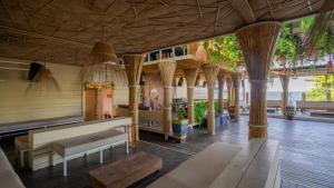 a living room with a couch and tables and trees at Hotel Pousada Brava Club in Búzios