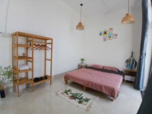 a bedroom with a bed and a book shelf at Nhi Homestay Phòng đơn 1 in Rạch Giá