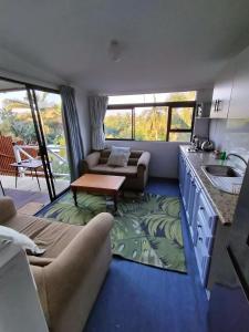 a living room with a couch and a table at Ocean Walk Starfish in Zinkwazi Beach +5 photos