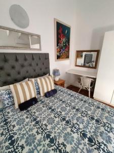 a bedroom with a bed with a blue and white bedspread at Ocean Walk Starfish in Zinkwazi Beach