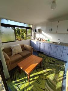 a living room with a couch and a table at Ocean Walk Starfish in Zinkwazi Beach
