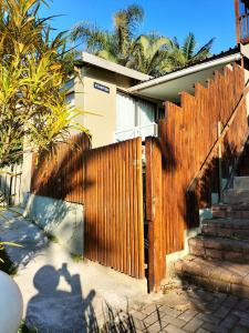 a fence in front of a house with a gate at Ocean Walk Starfish in Zinkwazi Beach