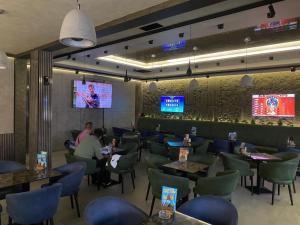 a restaurant with people sitting at tables in a room at Porto Apartmani in Zvornik