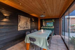 a dining room with a table and chairs at B&B de Wiekeborg in Oude Pekela