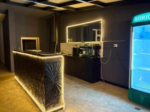 a room with a bar with a counter and a mirror at Mziuri Guest House in Ureki