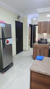 a kitchen with a refrigerator and a counter top at Fahd palm beach chalet in Ain Sokhna