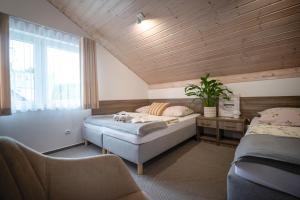 a bedroom with two beds and a window at DOM GOŚCINNY ROMA in Rewal