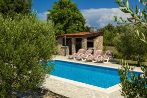 a villa with a swimming pool and lounge chairs at My Dalmatia - Villa Mandorla with private pool and Jacuzzi in Zadar